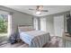 Comfortable bedroom with a ceiling fan, hardwood floors, and a window letting in natural light at 205 Twin Oaks Dr, Angier, NC 27501