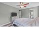Cozy bedroom with hardwood floors, a ceiling fan, and a TV on a wooden stand at 205 Twin Oaks Dr, Angier, NC 27501
