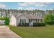 Charming single-story home with a well-manicured lawn, inviting curb appeal, and a concrete driveway at 205 Twin Oaks Dr, Angier, NC 27501