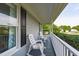 Inviting front porch featuring two white rocking chairs and decorative columns at 205 Twin Oaks Dr, Angier, NC 27501
