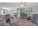 Spacious living room featuring hardwood floors, comfortable seating, and a ceiling fan at 205 Twin Oaks Dr, Angier, NC 27501