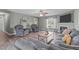 Comfortable living room featuring hardwood floors, grey walls, and a fireplace with TV above at 205 Twin Oaks Dr, Angier, NC 27501
