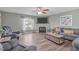 Bright living room with a fireplace, cozy seating, hardwood floors, and a large TV at 205 Twin Oaks Dr, Angier, NC 27501