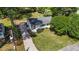 Aerial view of a charming white brick home with a lush green lawn and gravel driveway at 207 N Aiken St, Fuquay Varina, NC 27526