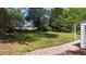 Spacious backyard featuring lush green grass and mature trees at 207 N Aiken St, Fuquay Varina, NC 27526