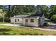 Back of the home showing white brick, gravel along exterior wall, and small room addition at 207 N Aiken St, Fuquay Varina, NC 27526