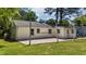 Home's backyard featuring gravel area along the exterior brick and lush green grass at 207 N Aiken St, Fuquay Varina, NC 27526