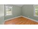 Cozy bedroom with two windows and hardwood flooring at 207 N Aiken St, Fuquay Varina, NC 27526