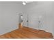 Bright bedroom with hardwood floors, closet, and overhead fan at 207 N Aiken St, Fuquay Varina, NC 27526