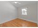 Well lit bedroom with hardwood floors and light gray wallpaper at 207 N Aiken St, Fuquay Varina, NC 27526