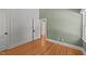 Light-filled bedroom featuring hardwood floors and a closet at 207 N Aiken St, Fuquay Varina, NC 27526