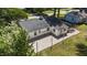 Aerial view of a well-maintained home featuring a dark roof and gravel yard at 207 N Aiken St, Fuquay Varina, NC 27526