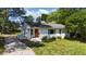 Charming white brick home with a well-maintained lawn and gravel driveway at 207 N Aiken St, Fuquay Varina, NC 27526