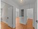 Hallway features gleaming hardwood floors and neutral walls at 207 N Aiken St, Fuquay Varina, NC 27526