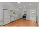Bright kitchen boasts stainless steel appliances, marble countertops, and farmhouse sink at 207 N Aiken St, Fuquay Varina, NC 27526