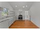 Modern kitchen featuring white cabinets, marble countertops, and stainless steel appliances at 207 N Aiken St, Fuquay Varina, NC 27526