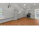 Bright kitchen with white cabinets, marble countertops, stainless appliances, and hardwood floors at 207 N Aiken St, Fuquay Varina, NC 27526