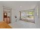 Bright sunroom featuring white-painted brick, board ceiling, and large windows for plenty of natural light at 207 N Aiken St, Fuquay Varina, NC 27526