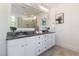 Elegant bathroom featuring double vanity, granite counters, and walk-in shower at 208 Vervain Way, Holly Springs, NC 27540