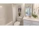 Well-lit bathroom featuring a combined shower and tub, as well as a modern vanity at 208 Vervain Way, Holly Springs, NC 27540