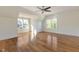 Light-filled bedroom offering hardwood floors and a view of the neighborhood at 208 Vervain Way, Holly Springs, NC 27540