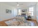 Bright bedroom with a cozy bed, complemented by natural light streaming through two windows at 208 Vervain Way, Holly Springs, NC 27540