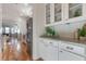 Open-concept kitchen with granite counters, white cabinets, and stainless steel appliances at 208 Vervain Way, Holly Springs, NC 27540