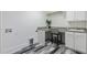 Functional laundry room with counter, sink, and wood look tile flooring at 208 Vervain Way, Holly Springs, NC 27540