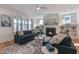 Cozy living room featuring stylish seating, a ceiling fan and a view of the fireplace and shelves at 208 Vervain Way, Holly Springs, NC 27540