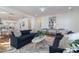 Comfortable living room featuring stylish furnishings and decor, with wood floors and bright light at 208 Vervain Way, Holly Springs, NC 27540