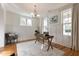 Well-lit office boasts hardwood floors, white wainscoting, and neutral decor at 208 Vervain Way, Holly Springs, NC 27540