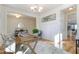 Bright office space with hardwood floors, white wainscoting, modern lighting and a decorative rug at 208 Vervain Way, Holly Springs, NC 27540