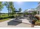 Outdoor dining area with ample seating and a golf course view, ideal for entertaining at 208 Vervain Way, Holly Springs, NC 27540