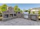 Outdoor kitchen featuring a built-in grill and pizza oven, ideal for entertaining at 208 Vervain Way, Holly Springs, NC 27540