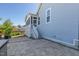 Back patio with access to a charming screened-in porch that enhances the home's appeal at 208 Vervain Way, Holly Springs, NC 27540