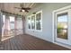 Enclosed back porch with a ceiling fan and outdoor curtains for privacy at 208 Vervain Way, Holly Springs, NC 27540