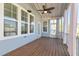 Covered porch featuring outdoor curtains and a ceiling fan, perfect for relaxation at 208 Vervain Way, Holly Springs, NC 27540