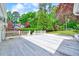 Relaxing backyard space offering a spacious deck, lush landscaping and serene privacy at 212 Ronaldsby Dr, Cary, NC 27511