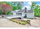 Backyard deck with white railings leads to a stone patio, complemented by lush landscaping and a well-maintained lawn at 212 Ronaldsby Dr, Cary, NC 27511