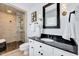 Stylish bathroom with a tiled walk-in shower, elegant vanity with granite countertop, and modern fixtures at 212 Ronaldsby Dr, Cary, NC 27511