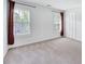 Spacious bedroom with ample natural light from two windows and a closet with shutter doors at 212 Ronaldsby Dr, Cary, NC 27511