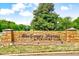 Stone entrance sign for MacGregor Downs Country Club under a blue sky at 212 Ronaldsby Dr, Cary, NC 27511