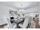 Elegant dining room with chandelier, hardwood floors, and seating for six at 212 Ronaldsby Dr, Cary, NC 27511