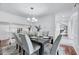 Bright dining room features wainscoting, modern chandelier, and neutral decor for elegant meals and gatherings at 212 Ronaldsby Dr, Cary, NC 27511