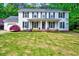 Traditional two-story home with a well-manicured lawn, attractive landscaping and black window shutters at 212 Ronaldsby Dr, Cary, NC 27511