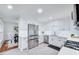 Contemporary kitchen boasts stainless steel appliances, white cabinetry, and tiled backsplash, blending style with functionality at 212 Ronaldsby Dr, Cary, NC 27511
