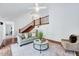 Inviting living room boasts natural light, hardwood floors, and staircase, creating a warm and welcoming atmosphere at 212 Ronaldsby Dr, Cary, NC 27511