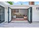 Inviting living room visible through folding glass doors, with a seating area and bright natural light at 212 Ronaldsby Dr, Cary, NC 27511