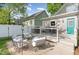 Outdoor entertaining space with a lounge and dining area and white privacy fence at 219 Northwood Cir, Durham, NC 27701