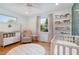 Charming Bedroom featuring pink accents, hardwood floors, and a bright and inviting atmosphere at 219 Northwood Cir, Durham, NC 27701
